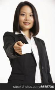 Studio Portrait Of Chinese Businesswoman Offering Business Card