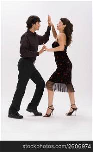 Studio portrait of couple dancing