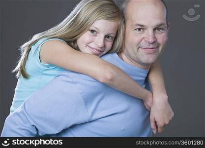 Studio portrait of daughter embracing father