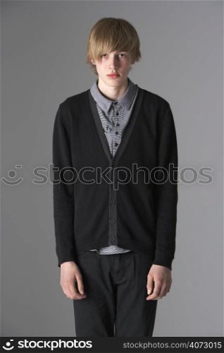 Studio Portrait Of Fashionably Dressed Teenage Boy