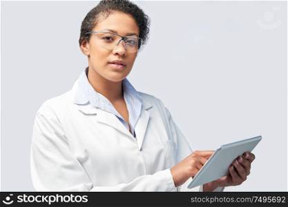 Studio Portrait Of Female Laboratory Technician Working With Digital Tablet