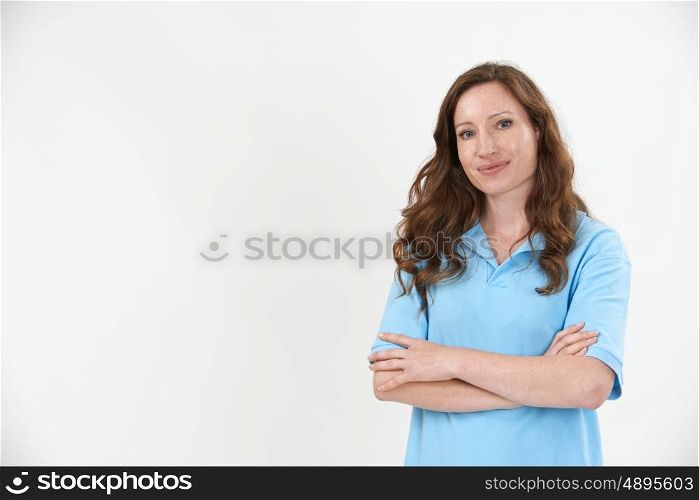 Studio Portrait Of Female Staff Member Wearing Uniform Against White Background