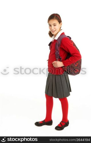 Studio Portrait Of Female Student In Uniform With Backpack