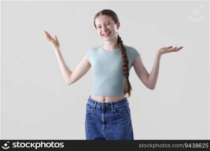 Studio Portrait Of Happy Smiling And Confident Teenage Girl With Arms Outstretched Looking At Camera