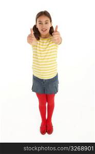 Studio Portrait Of Happy young Girl Giving Thumbs Up Gesture