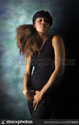 Studio portrait of hip African-American young adult woman looking at viewer.