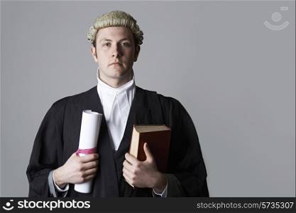 Studio Portrait Of Lawyer Holding Brief And Book