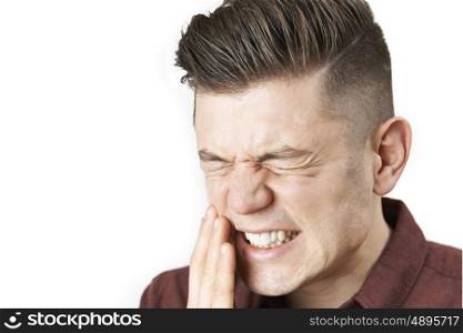 Studio Portrait Of Man Suffering With Toothache