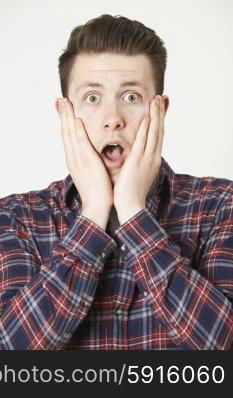 Studio Portrait Of Man With Shocked Expression