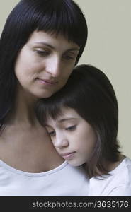 Studio portrait of mother and daughter