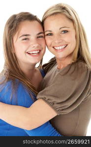 Studio Portrait Of Mother Hugging Daughter