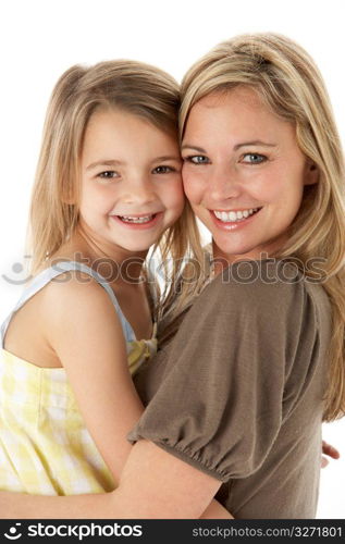 Studio Portrait Of Mother Hugging Young Daughter
