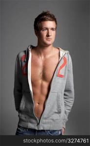 Studio Portrait Of Sexy Young Man Wearing Hooded Sweat Top