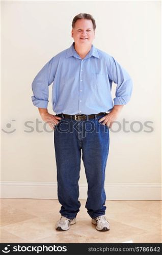 Studio Portrait Of Smiling Overweight Man