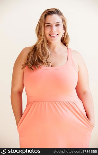 Studio Portrait Of Smiling Overweight Woman