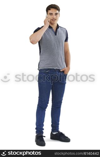 Studio Portrait Of Teenage Boy Talking On Mobile Phone