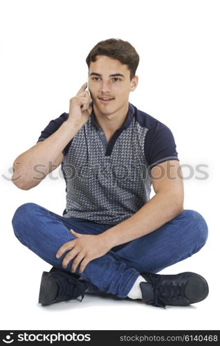 Studio Portrait Of Teenage Boy Talking On Mobile Phone