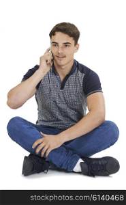 Studio Portrait Of Teenage Boy Talking On Mobile Phone