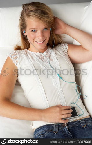 Studio Portrait Of Teenage Girl Listening To MP3 Player