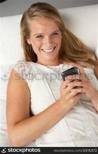 Studio Portrait Of Teenage Girl With Mobile Phone