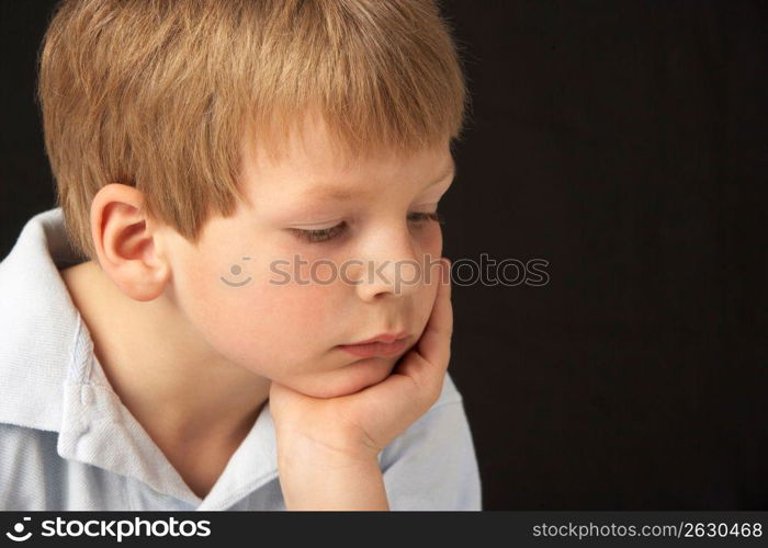 Studio Portrait Of Thoughtful Young Boy