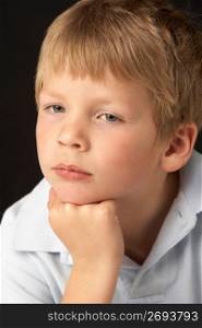 Studio Portrait Of Thoughtful Young Boy