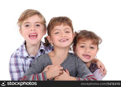 Studio portrait of three young siblings