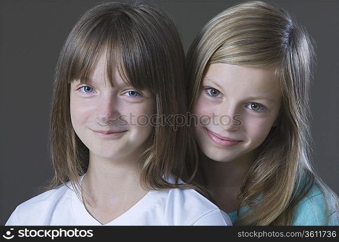 Studio portrait of two girl smiling