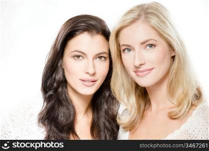 studio portrait of two young caucasian women, isolated over white