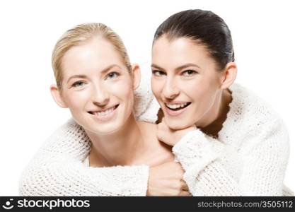 studio portrait of two young happy caucasian women, isolated over white