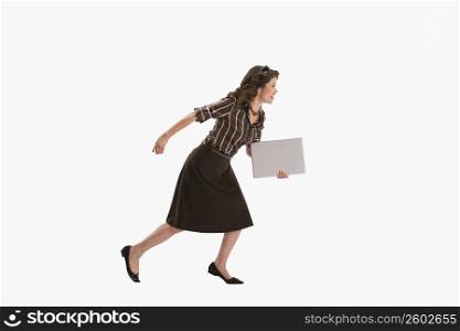 Studio portrait of woman running