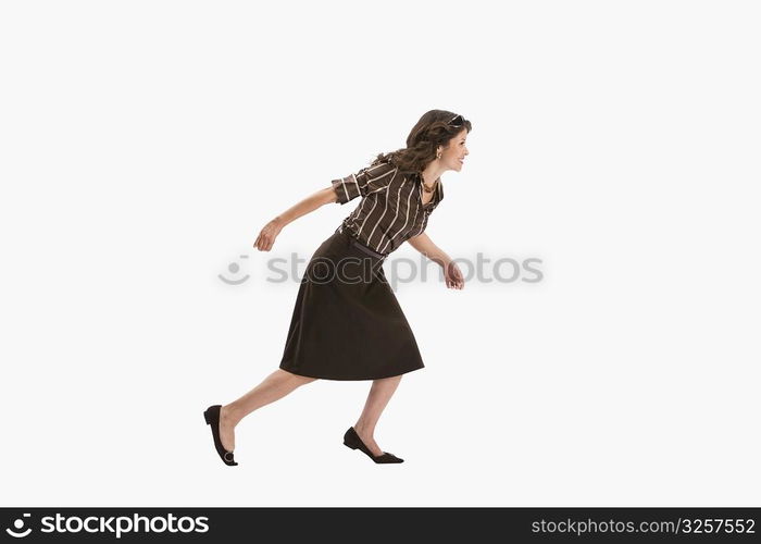 Studio portrait of woman running