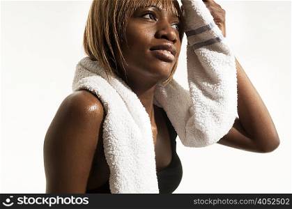 Studio portrait of woman with towel