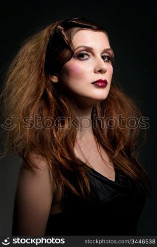 studio portrait of young beautiful woman with vintage hair style and make-up