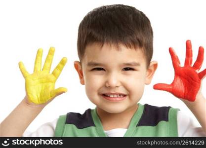 Studio Portrait Of Young Boy With Painted Hands