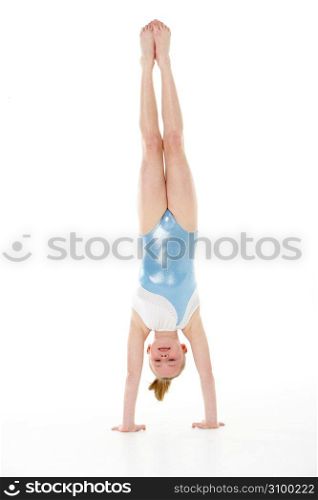 Studio Portrait Of Young Female Gymnast Doing Handstand