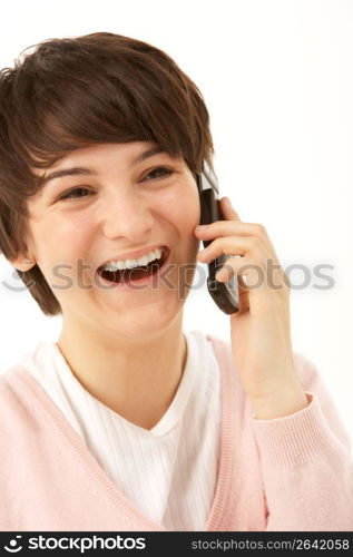 Studio Portrait Of Young Girl Using Mobile Phone