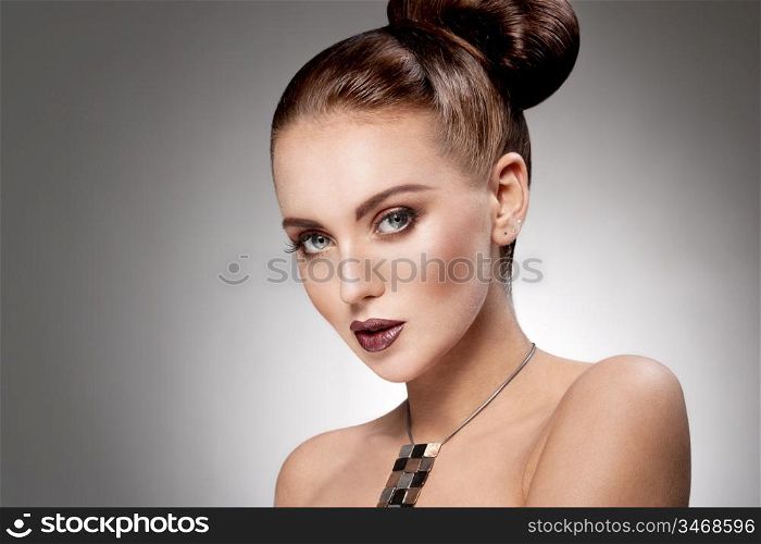 studio portrait of young gorgeous brunette wearing necklace