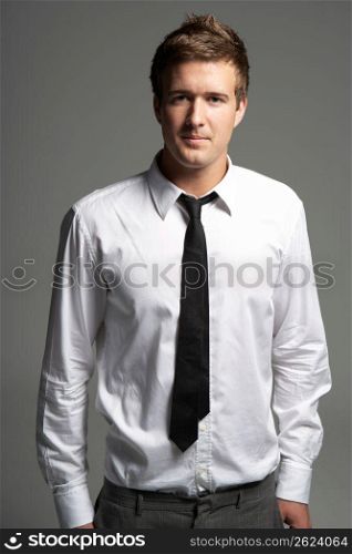 Studio Portrait Of Young Man Wearing Shirt And Tie