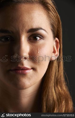 Studio Portrait Of Young Woman Crying
