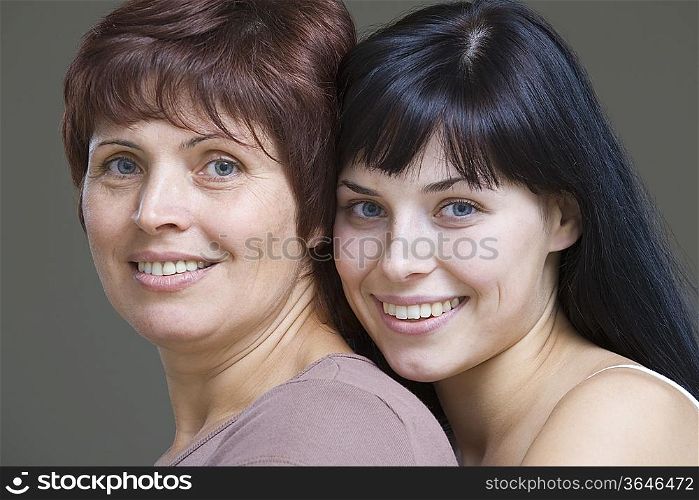 Studio portrait of young woman embracing mother