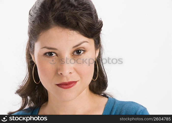 Studio portrait of young woman looking at camera