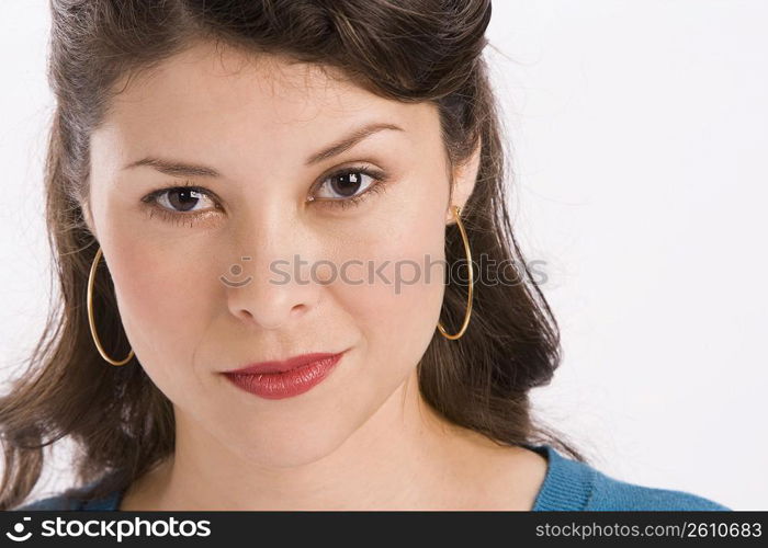 Studio portrait of young woman looking at camera