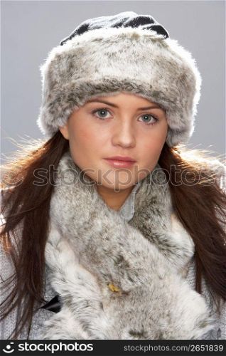 Studio Portrait Of Young Woman Wearing Fur Hat And Wrap
