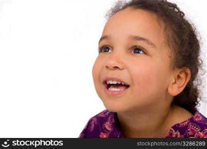 Studio shot of a beautiful mixed race girl looking skywards and smiling. The background has been dropped out.