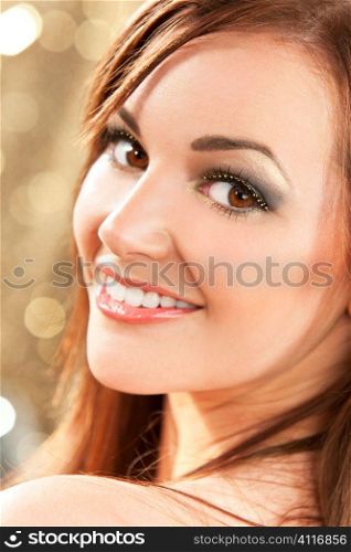 Studio shot of a beautiful young brunette woman with striking brown eyes and a great smile.