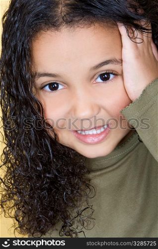 Studio shot of a beautiful young mixed race girl looking cute