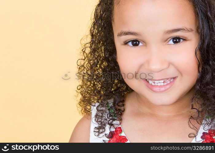 Studio shot of a beautiful young mixed race girl smiling