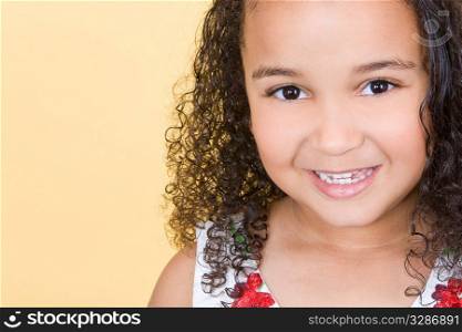 Studio shot of a beautiful young mixed race girl smiling