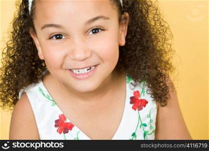Studio shot of a beautiful young mixed race girl smiling and having fun